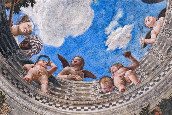 Ducal Palace: vault of the “Bridal Chamber or Camera Picta", which is a room located in the north-east tower of the Castle of San Giorgio in Mantua. It is famous for the cycle of frescoes that covers its walls, a masterpiece by Andrea Mantegna, created between 1465 and 1474.
Detail of the oculus of the vault where you can see a balustrade from which a court lady leans out, accompanied by her black servant, and some putti.
Palazzo Ducale, Mantova (MN) - Mantua, Lombardia - Lombardy, Italia - Italy