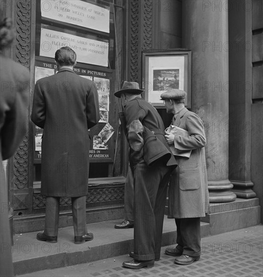 Men Reading News Bulletins and Looking at News Pictures outside Baltimore News Building, Baltimore, Maryland, USA, Marjorie Collins for Office of War Information, April 1943