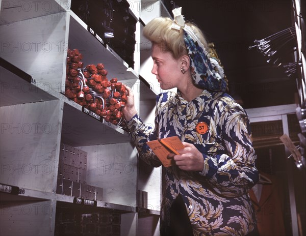 Female Clerk Checking to see if proper Numbers of Parts were Received and Placed in Proper Bins in Stock Room, North American Aviation, Inc., Manufacturer of B-25 Bomber and P-51 Mustang Fighter Planes, Inglewood, California, USA, Alfred T. Palmer for Office of War Information, October 1942