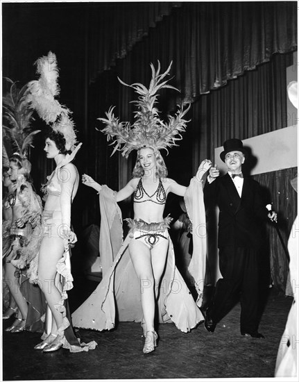 Emcee Leading Chorus Girl Across Stage during Performance to Raise Money for War Bonds During World War II, Vallejo, California, USA, 1943