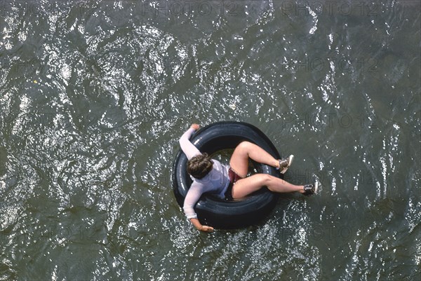 Young Woman floating in Inner Tube