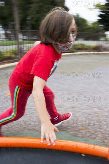 Young Boy with Protective Face Mask Playing at Playground