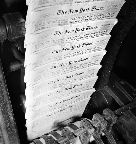 New York Times finished papers coming out of cutting and folding machines on rapidly moving belt, New York Time press room, New York City, New York, USA, Marjory Collins, U.S. Office of War Information, September 1942