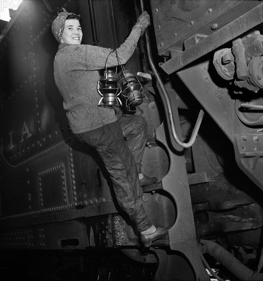 Mrs. Mary Ankrom, twenty-eight, mother of six children, employed at Pennsylvania Railroad engine house as a locomotive preparer, earning fifty-eight cents per hour. Her father takes care of her children while she is working, Pitcairn, Pennsylvania, USA, Marjory Collins, U.S. Office of War Information, May 1943