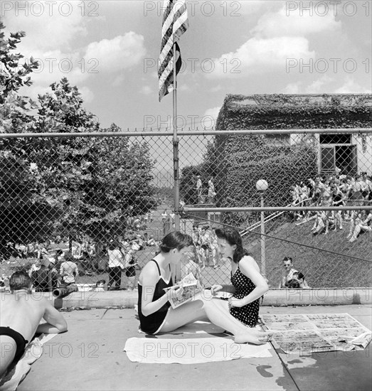 Two young women relaxing by community pool, Washington, D.C., USA, Marjory Collins, U.S. Office of War Information, July 1942