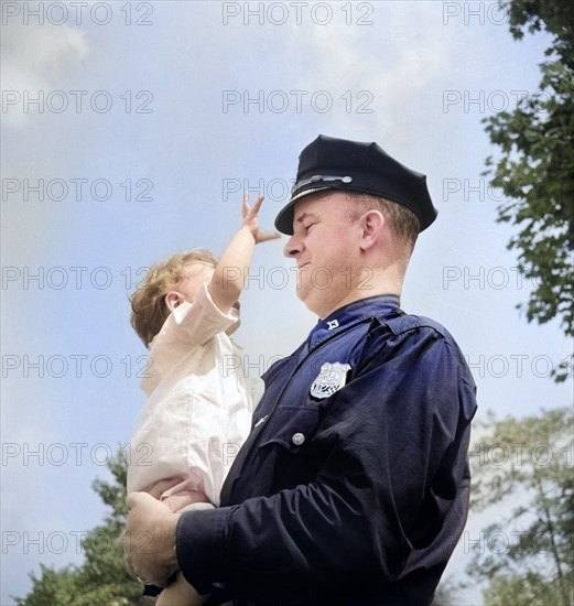 Irish-American policeman holding child, Central Park, New York City, New York, USA, Marjory Collins, U.S. Office of War Information, September 1942