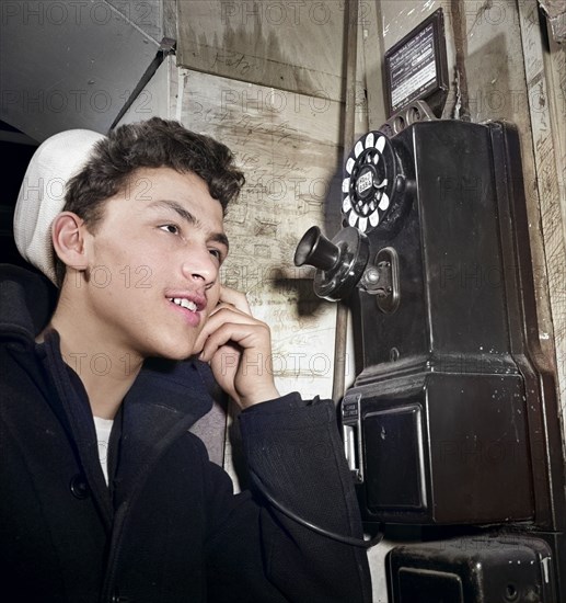 16-year-old teen boy who is in U.S. Naval Reserve talking on pay telephone, New York City, New York, USA, Marjory Collins, U.S. Office of War Information, January 1943