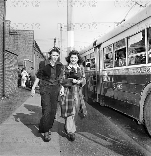 Two Young Women catching the trackless trolleys after work at 4pm, Baltimore, Maryland, USA, Marjory Collins, U.S. Office of War Information, April 1943