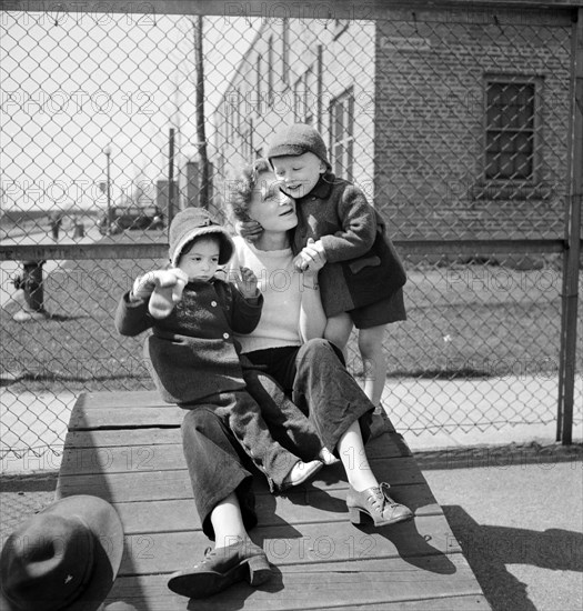 Mother with her two children at Lakeview nursery school for children of working mothers, operated by board of Education at tuition fee of three dollars weekly, Buffalo, New York, USA, Marjory Collins, U.S. Office of War Information, May 1942