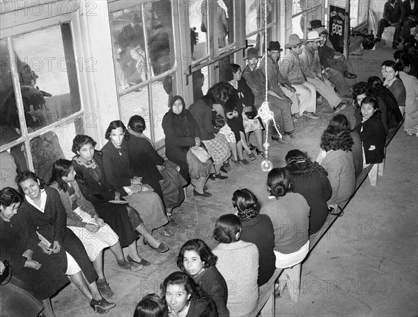 Mexican pecan workers waiting in union hall for assignment to work. San Antonio, Texas, USA, Russell Lee, U.S. Farm Security Administration, March 1939