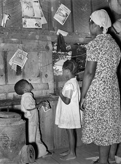 Wife of sharecropper teaching her children their ABC's, near Marshall, Texas, USA, Russell Lee, U.S. Farm Security Administration, March 1939