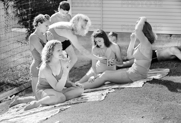 Group of young sun bathers at park swimming pool, Caldwell, Idaho, USA, Russell Lee, U.S. Farm Security Administration, July 1941