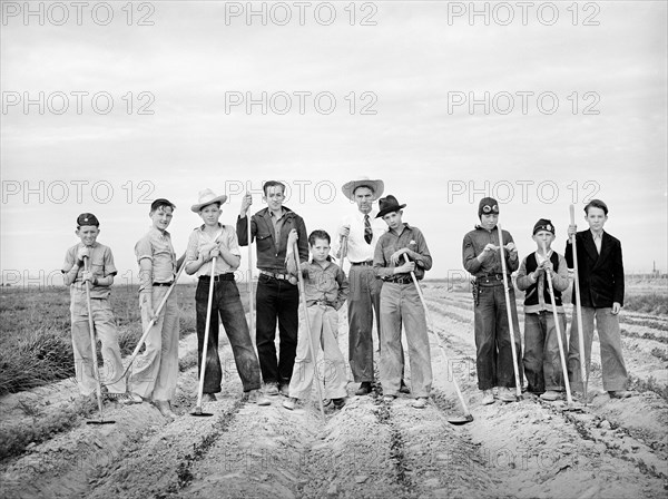 Boys learning to garden in vocational training class provided for in the Smith-Hughes bill, FSA (Farm Security Administration) farm workers' community, Eleven Mile Corner, Arizona, USA, Russell Lee, U.S. Farm Security Administration, February 1942