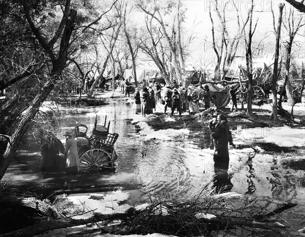 Brigham Young and group of Mormons encamped at Sugar Creek while heading west, on-set of the film, "Brigham Young", 20th Century-Fox, 1940