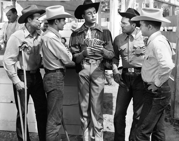 Casey Tibbs (2nd left), Scott Brady (center) on-set of the film, "Bronco Buster", Universal Pictures, 1952