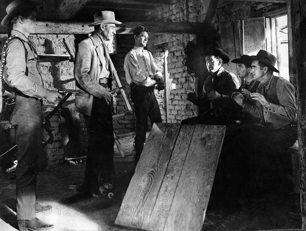 Randolph Scott (center left), Manuel Rojas (center right), on-set of the film, "Buchanan Rides Alone", Columbia Pictures, 1958