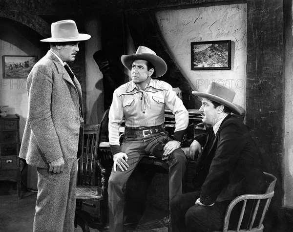 Johnny Mack Brown (center), Robert Barron (right), on-set of the film, "Cheyenne Roundup", Universal Pictures, 1943