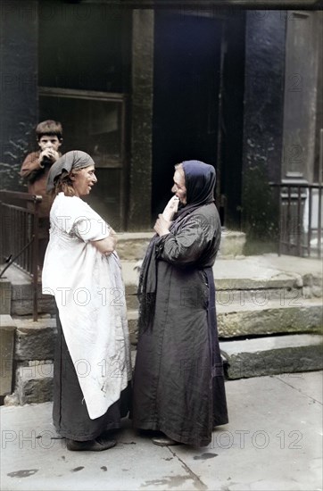 Two Syrian women talking in front of residential building, New York City, New York, USA, Bain News Service, 1916