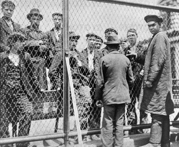 Immigrants scheduled for deportation being held in detention pen on roof of main building, Ellis Island, New York City, New York, USA, Matine Company, 1902