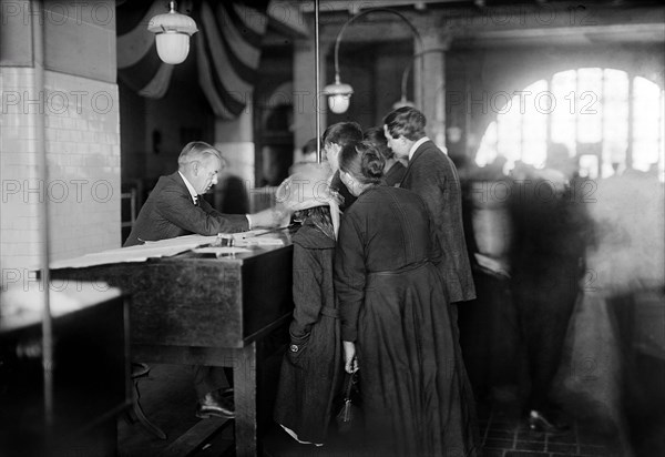 Group of arriving immigrants in examination room, Ellis Island, New York City, New York, USA, Bain News Service, 1920