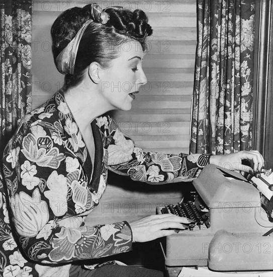 Gypsy Rose Lee, portrait, seated at typewriter, Fred Palumbo, New York World-Telegram & Sun Collection, 1956