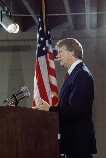 U.S. President Jimmy Carter at podium during news conference, three-quarter length profile portrait, Washington D.C., USA, Bernard Gotfryd, between 1977 and 1981