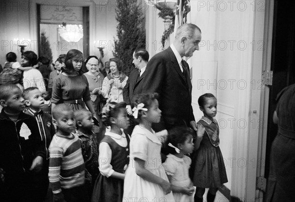 U.S. President Lyndon Johnson accompanying children of poverty to party at White House, Washington, D.C., USA, Marion S. Trikosko, U.S. News & World Report Magazine Photograph Collection, December 16, 1964