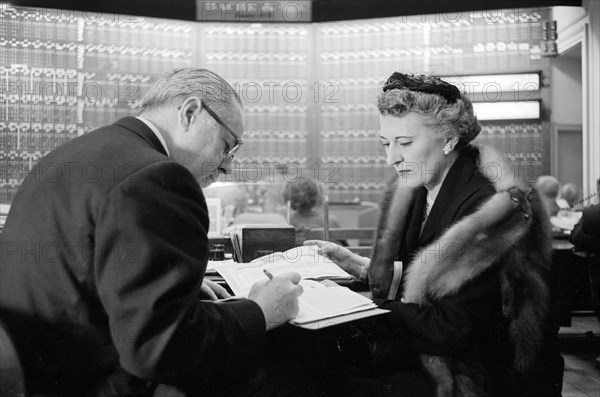 Woman with an investment counselor, Thomas J. O'Halloran, U.S. News & World Report Magazine Photograph Collection, 1958