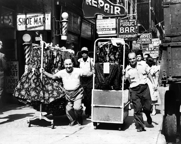 Men pulling racks of clothing on busy sidewalk in Garment District, New York City, New York, USA, Al Ravenna, New York World-Telegram and the Sun Newspaper Photograph Collection, 1955