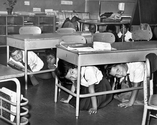 Young schoolchildren crawl under desks during air raid drill, P.S. 58, Carroll & Smith Streets, Brooklyn, New York City, New York, USA, Walter Albertin, New York World-Telegram and the Sun Newspaper Photograph Collection, 1962