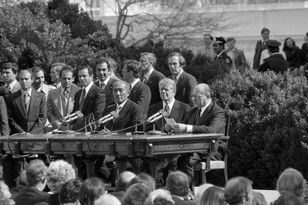 Egyptian President Anwar Sadat, U.S. President Jimmy Carter, Israeli Prime Minister Menachem Begin, and others at the signing of the Egypt-Israel peace treaty, outside the White House, Washington, D.C., USA, Warren K. Leffler, U.S. News & World Report Magazine Photograph Collection, March 26, 1979