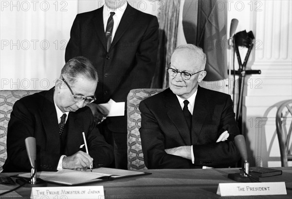 Prime Minister Nobusuke Kishi of Japan signing Mutual Cooperation and Security Treaty while seated next to U.S. President Dwight Eisenhower, East Room of White House, Washington, D.C., USA, Marion K. Trikosko, U.S. News & World Report Magazine Photograph Collection, January 19, 1960