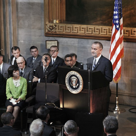 U.S. President Lyndon Johnson delivering remarks from behind podium during signing ceremony for the Voting Rights Act, Luci Johnson seated left, Rotunda, U.S. Capitol, Washington, D.C., USA, Yoichi Okamoto, August 6, 1965