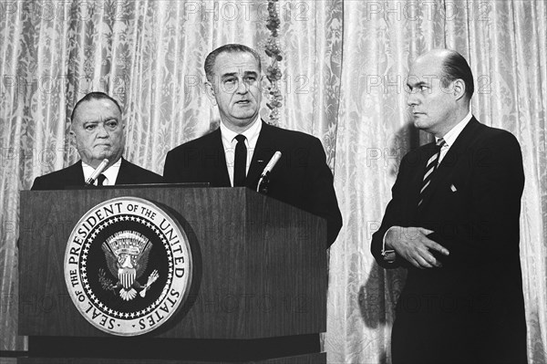 U.S. President Lyndon B. Johnson with FBI Director J. Edgar Hoover (left) and U.S. Attorney General Nicholas Katzenbach (right), as he announced the capture of Ku Klux Klan members suspected of murdering civil rights worker in Alabama, Washington, D.C., USA, Yoichi Okamoto, March 26, 1965