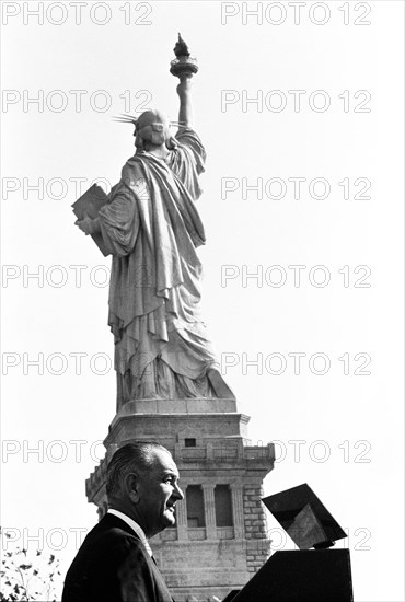 U.S. President Lyndon B. Johnson speaking at podium with Statue of Liberty in background before signing the Immigration and Nationality Act of 1965, Liberty Island, New York City, New York, USA, Yoichi Okamoto, October 3, 1965