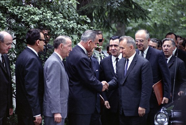 L-R: U.S. Secretary of State Dean Rusk, William Krimer (Pres. Johnson's interpreter), U.S. Ambassador to the Soviet Union Llewellyn Thompson, U.S. President Lyndon B. Johnson shaking hands with Soviet Premier Aleksei Kosygin with Soviet Foreign Minister Andrei Gromyko & Soviet Ambassador Anatoly Dobrynin behind Kosygin, Glassboro Summit Conference, Glassboro State College, Glassboro, New Jersey, USA, Yoichi Okamoto, June 23, 1967