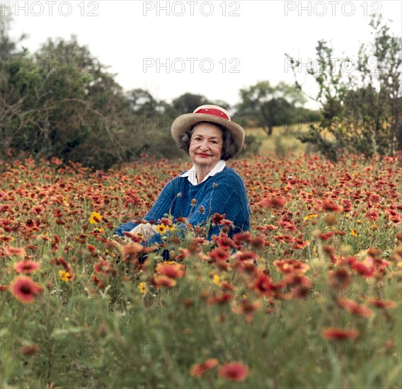 Former U.S. First Lady Lady Bird Johnson sitting in field of wildflowers, Texas, USA, Frank Wolfe, May 10, 1990