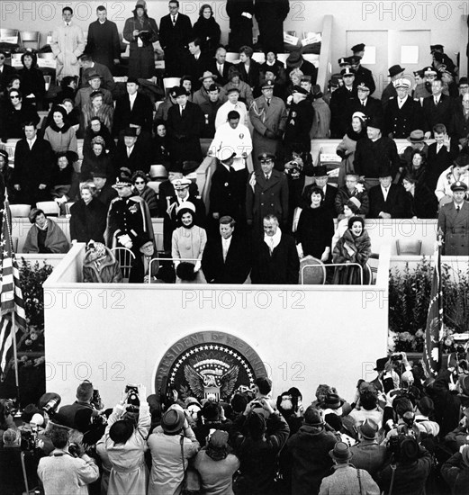 Joseph Kennedy, Rose Kennedy, Jacqueline Kennedy, U.S. President John Kennedy, U.S. Vice President Lyndon Johnson, Lady Bird Johnson and others on reviewing stand during inaugural parade, Pennsylvania Avenue, Washington, D.C., USA, Abbie Rowe, White House Photographs, January 20, 1961