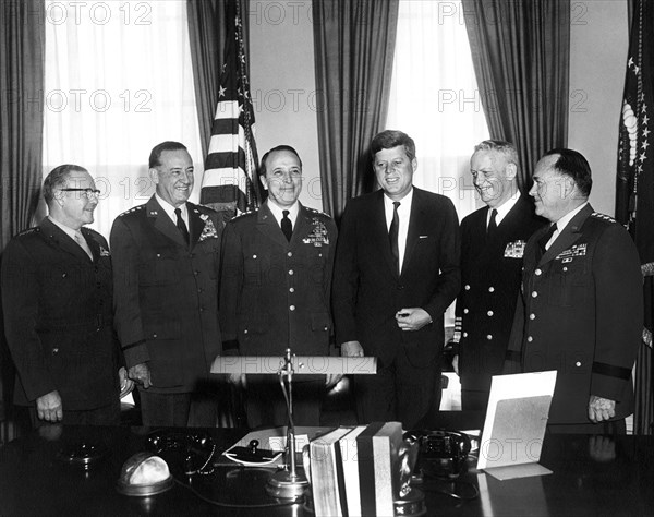 U.S. President John Kennedy (3rd from right) meeting with Joint Chiefs of Staff. (L-R) Commandant of the U.S. Marine Corps General David M. Shoup; Chief of Staff of the U.S. Air Force General Thomas D. White; Chairman of the Joint Chiefs of Staff General Lyman Lemnitzer; Chief of Staff of the U.S. Navy Admiral Arleigh A. Burke; Chief of Staff of the U.S. Army General George H. Decker, Oval Office, White House, Washington, D.C., USA, Abbie Rowe, White House Photographs, January 25, 1961