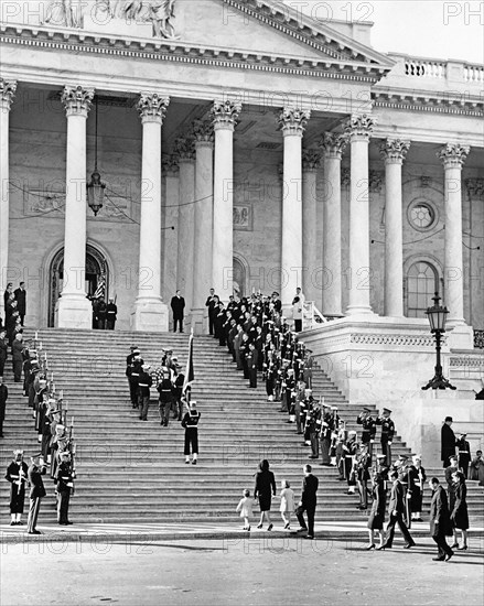 U.S. Honor Guard pallbearers carrying flag-draped casket of late U.S. President John Kennedy up steps of U.S. Capitol Building following funeral procession from White House, former U.S. First Lady Jacqueline Kennedy following with her children, Caroline Kennedy and John F. Kennedy, Jr., and U.S. Attorney General Robert Kennedy, Washington, D.C., USA, Abbie Rowe, White House Photographs, November 24, 1963