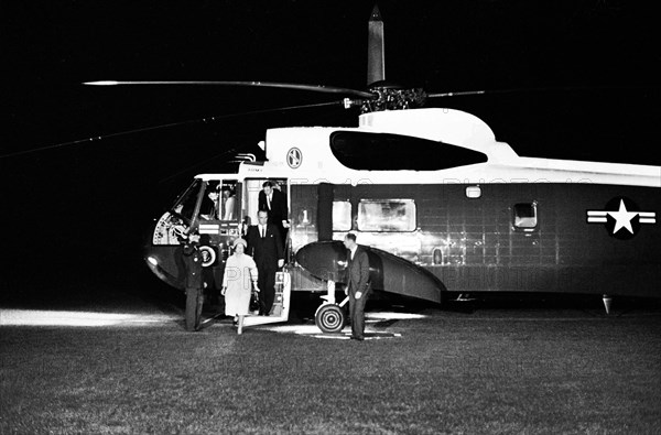 U.S. President Lyndon Johnson and First Lady Claudia 'Lady Bird' Johnson arriving on South Lawn from Dallas, Texas, via Andrews Air Force Base, Secretary of Defense, Robert S. McNamara, exiting U.S. Army helicopter behind President Johnson; Secret Service agent, Rufus Youngblood, standing right of stairs, White House, Washington, D.C., USA, Robert Knudsen, White House Photographs, November 22, 1963