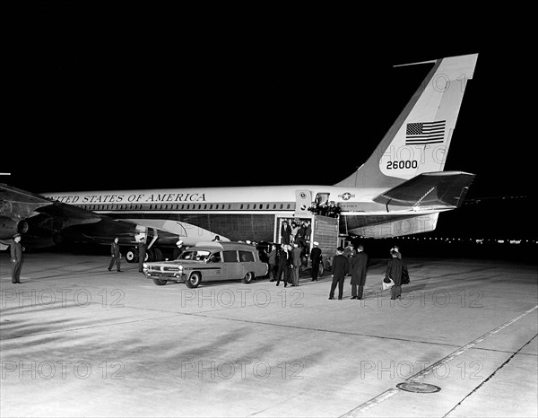 Late U.S. President John Kennedy’s casket being transferred from Air Force One to waiting ambulance, Jacqueline Kennedy and U.S. Attorney General, Robert Kennedy stand inside hydraulic lift, Andrews Air Force Base, Maryland, USA,  Cecil Stoughton, White House Photographs, November 22, 1963