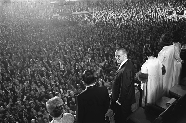 Muriel Humphrey, Vice President Hubert Humphrey, President Lyndon B. Johnson, Lady Bird Johnson, Lynda Johnson, and Luci Johnson stand before crowd on Inauguration night, National Guard Armory, Washington, D.C., USA, Yoichi Okamoto, January 18, 1965