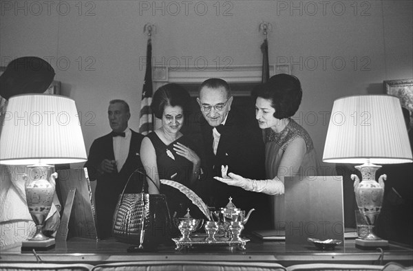 Indian Prime Minister Indira Gandhi, U.S. President Lyndon Johnson and Lady Bird Johnson exchanging gifts before state dinner honoring the Prime Minister, Yellow Oval Room, White House, Washington, D.C., USA, Yoichi Okamoto, March 28, 1966