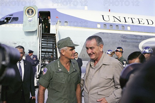 U.S. General William Westmoreland speaking with U.S. President Lyndon Johnson (Air Force One in background), during Johnson's visit to Cam Ranh Bay, South Vietnam, Yoichi Okamoto, December 23, 1967