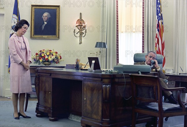 U.S. First Lady Claudia "Lady Bird" Johnson looking on as U.S. President Lyndon Johnson telephones the Kennedys after Senator. Robert F. Kennedy's assassination, Oval Office, White House, Washington, D.C., USA, Yoichi Okamoto, June 6, 1968