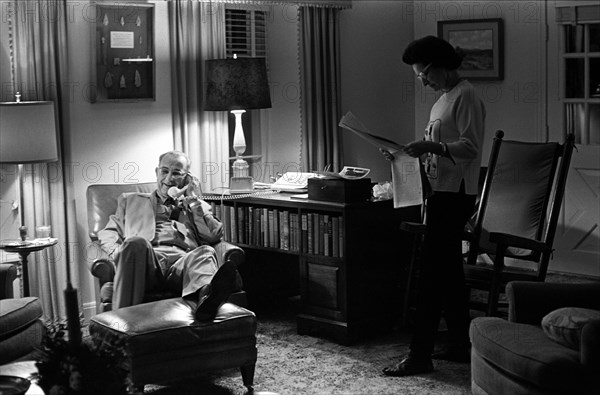 U.S. President Lyndon Johnson talking on telephone, Lady Bird Johnson reading newspaper on Christmas day at LBJ ranch, Stonewall, Texas, USA, Yoichi Okamoto, December 25, 1963