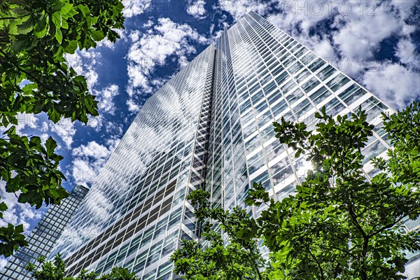 200 West Street, low angle view, building exterior surrounded by trees against clouds and blue sky, New York City, New York, USA