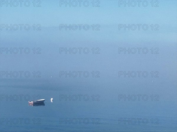 Moored rowboat at sea