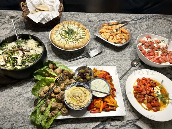 Arugula, farro and herb salad, roasted tomatoes with savory yogurt, feta salad, grilled shrimp and mezze platter